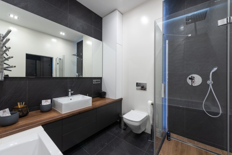 A contemporary bathroom featuring a sink ,bathtub and a beautiful glass shower bath